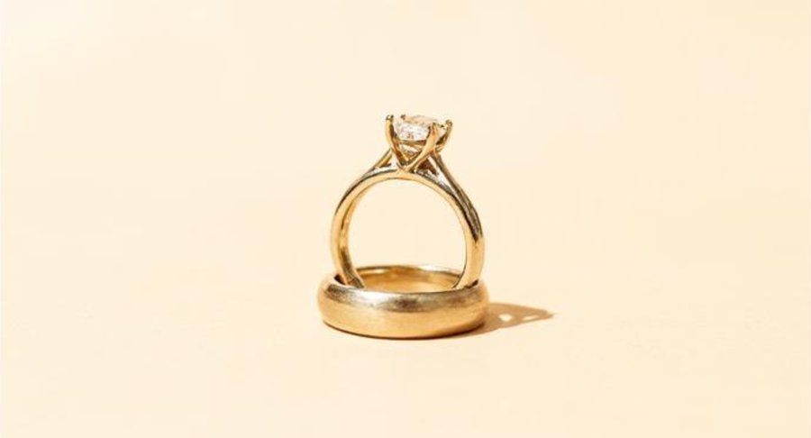 An illustration of an engagement ring resting inside a wedding band